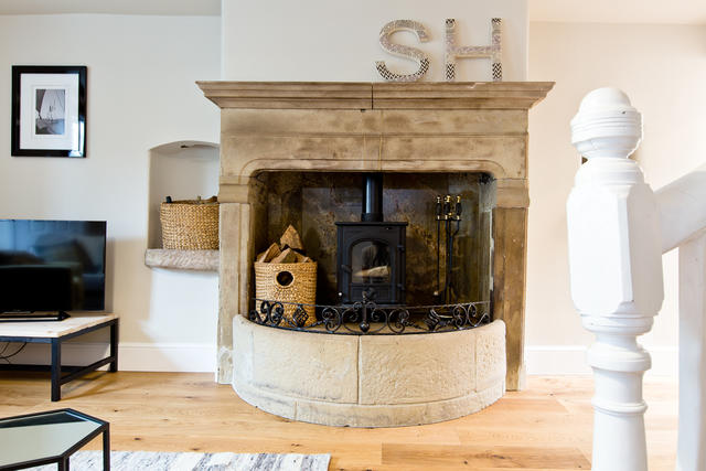 Lovely original fireplace complete with log burner