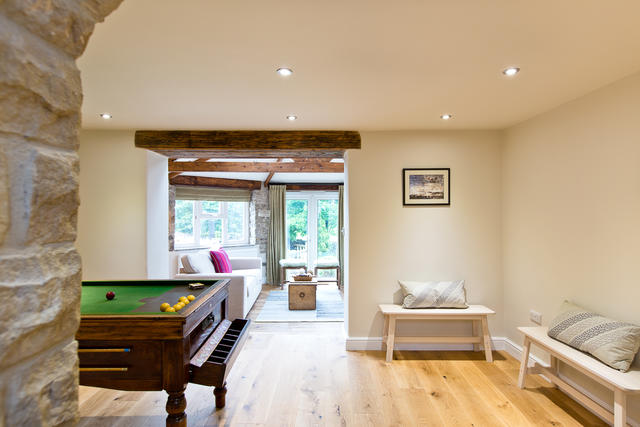 View from the billiards table room through to a light living space View from the billiards table room through to a light living space