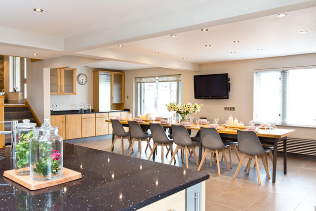 Dining for fourteen guests in the open plan kitchen/dining room