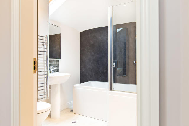 Shared family bathroom with shower over bath Shared family bathroom with shower over bath