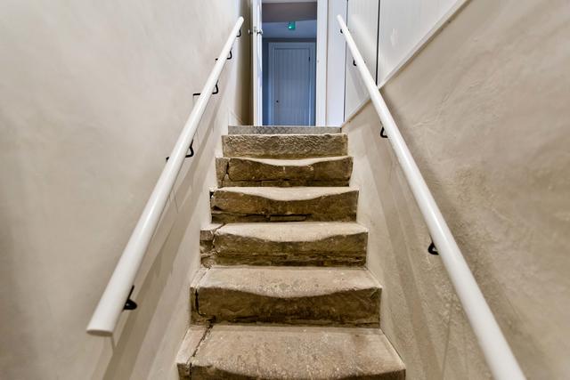 Original stone steps down to the cellar room in the Farmhouse