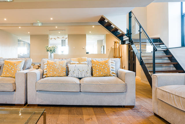 Comfy seating with view of the staircase up to the first floor bedrooms