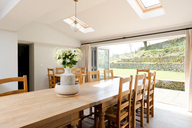 Huge dining table can seat up to 30, with views of the garden and patio area - perfect for a BBQ spot